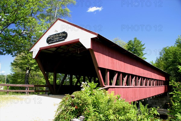 USA, New Hampshire, Conway, "Swift River Covered Bridge, wooden structure over water."