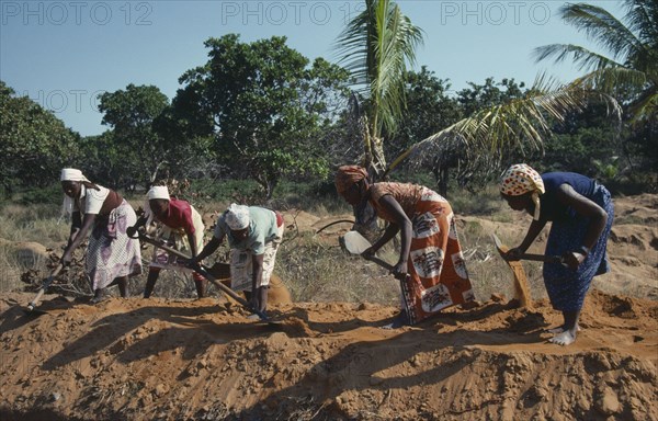 MOZAMBIQUE, People, UNILO road refurbishment.  Line of female labourers.