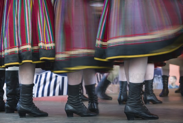 POLAND, Warsaw, "Detail of traditional dancers' costumes performing in the Old Town. Moving, blurred skirts and boots."