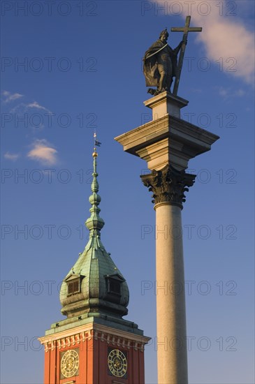 POLAND, Warsaw, "Detail of the Monument to Sigismund III in Plac Zamkowy, Castle Square with the Royal Castle behind with clocks on the tower."