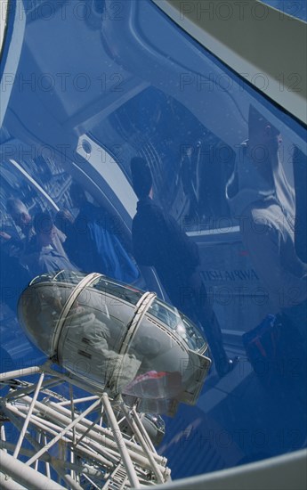 ENGLAND, London, British Airways London Eye. View of pods with people inside the capsule reflected in the curved glass.