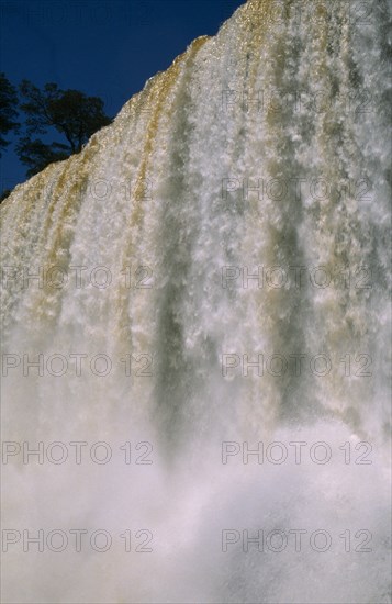 ARGENTINA, Iguazu Falls, Looking up at the water pouring over the edge with water spray.