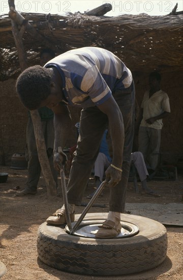 IVORY COAST, Transport, Man mending tyre puncture