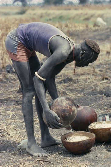 SUDAN, Tribal People, Preparation of millet porridge for Dinka wedding feast.