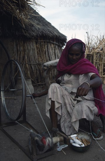SUDAN, Refugees, Ethiopian refugee woman spinning wool in International Labour Organisation sponsored self sufficiency scheme.