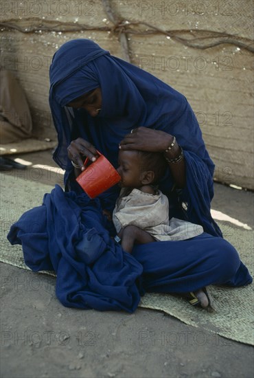 SUDAN, Red Sea Hills Province, Sinkat, Woman with malnourished child at Red Cross feeding centre.