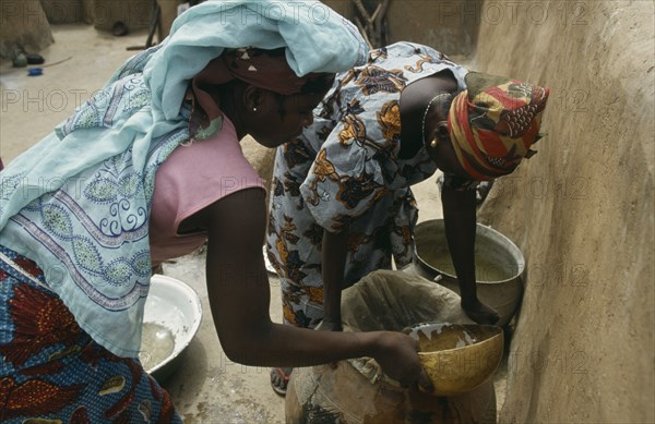 GHANA, Water, "Women filtering water to prevent guinea worm, a parasitic disease contracted when contaminated water is consumed and which can infect stagnant water."