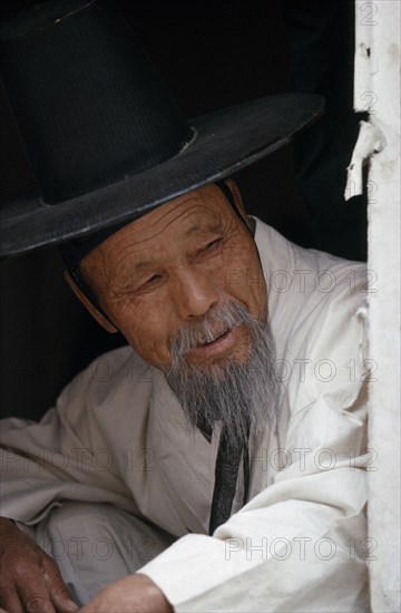 SOUTH KOREA, Seoul, Portrait of elderly Confucian Priest in traditional white robe and kat horsehair hat