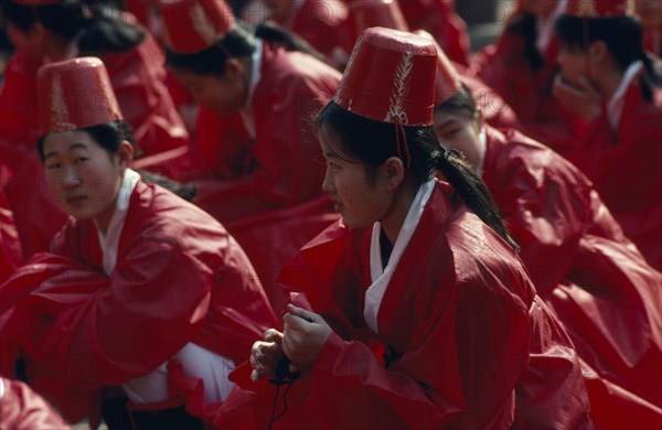 SOUTH KOREA, Seoul, Sung Kyon Kwan University. Sukcheon Ceremony to consecrate confucius. Girls dancers in red sat on ground