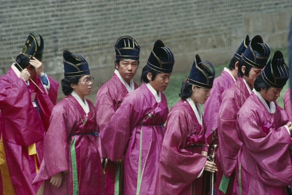 SOUTH KOREA, Seoul, Court musician and dancers in line entering memorial site containing spirit tablet of Yin Dynasty