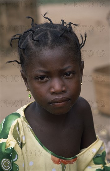 GHANA, People, Portrait of young girl from small village near Accra with her hair twisted into multiple short braids.