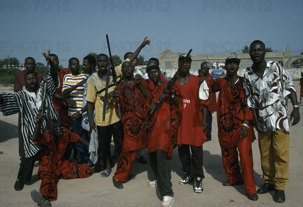 GHANA, Accra, Burial of an engineer.  The Asafo royal family guard call on the spirit of the dead man to “go to the land of shadows peacefully”.