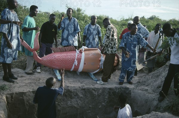 GHANA, South, Teshie, Burial of Ga tribal priestess of the sea god Kanjar in coffin made and painted to represent a mermaid following tradition of decorating coffin to reflect life of the deceased.