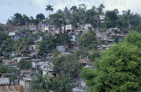 JAMAICA, Montego Bay, Norwood, "Overcrowded slum area, shanty housing on hillside with corrugated tin rooves."