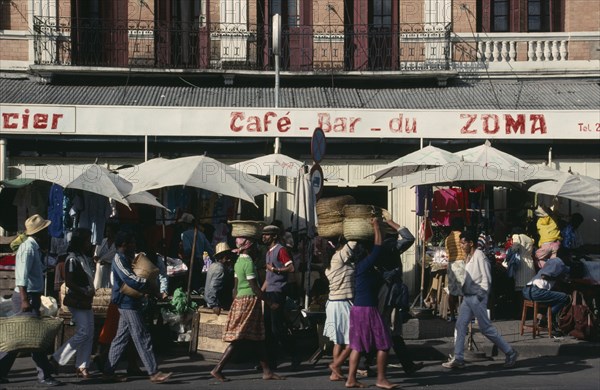 MADAGASCAR, Antananarivo, "Zoma Market.  Busy market scene with cafe bar, roadside stalls and people carrying baskets on their heads."