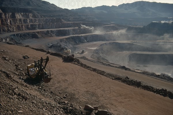 MAURITANIA, Zouerate, Iron mine.  Machinery working on terraces.