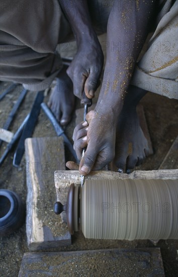 MALAWI, Zalewa, Kadzuwa Crafts.  Cropped view of craftsman using wood turner to produced fair trade carved items for export.