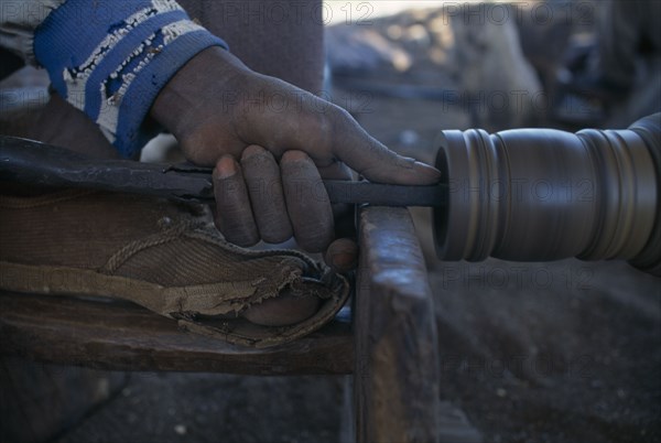 MALAWI, Zalewa, Kadzuwa Crafts.  Cropped view of craftsman using wood turner to produce fair trade carved items for export.