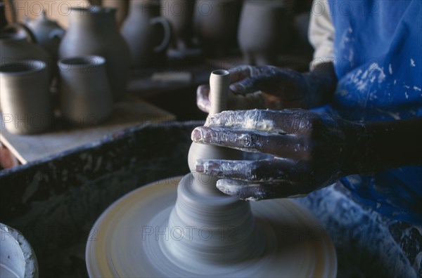 MALAWI, Dedza, Dedza Potteries producing Fair Trade goods for export. Cropped view of potter working at wheel.