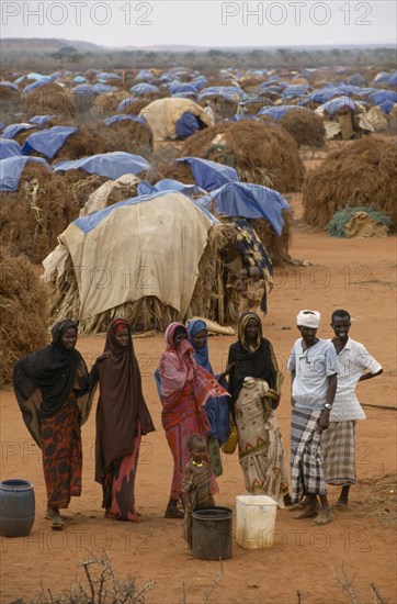 KENYA, Mandera, "Somali refugee camp run by UNHCR with a population of 55,000.  People waiting for water with tents spread out behind."