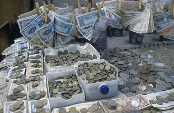 BRAZIL, Market, Stall with many different types of Brazilian coins and notes which have changed frequently.