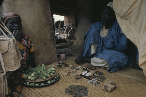 NIGERIA, Markets, Financial, Money changer with beads and jewellery also used to trade.