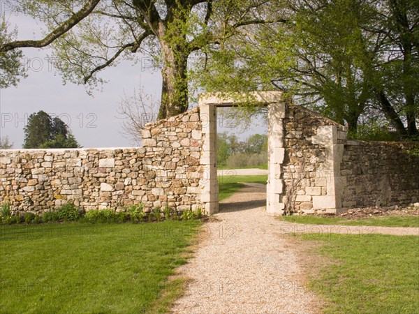 FRANCE, Deux Sevres Region, Poitiers, A doorway in the old stone wall surrounding the Chateau des Forges.