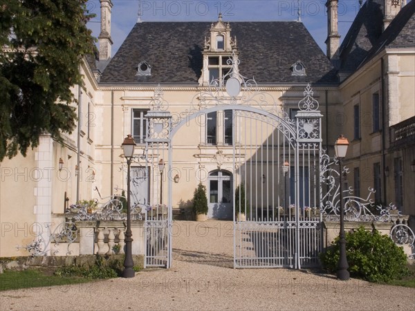 FRANCE, Deux Sevres Region, Poitiers, Iron entrance gate and lampposts in front of the Chateau des Forges.