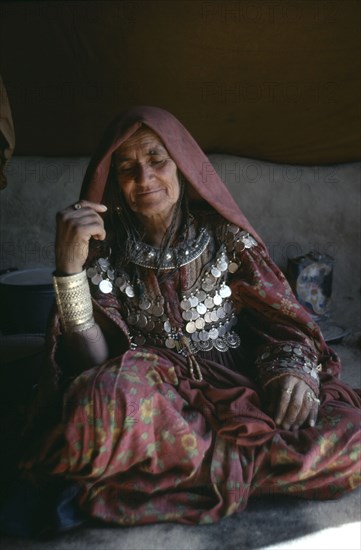 AFGHANISTAN, Paktia Province, Portrait of woman of the Jajia tribe wearing traditional dress and jewellery.
