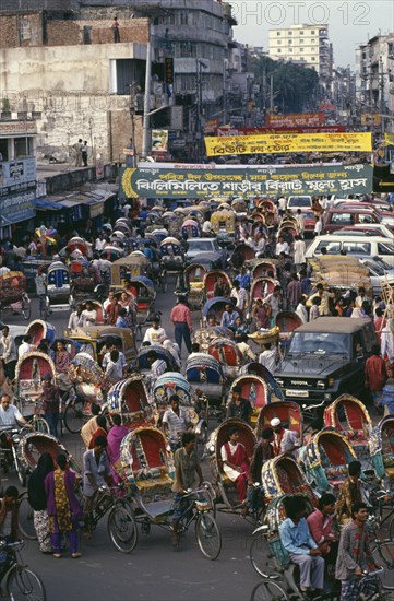 BANGLADESH, Dhaka, Street crowded with brightly painted and decorated rickshaws.