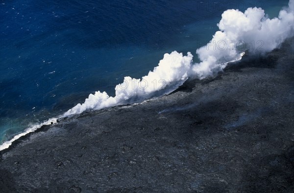 USA, Hawaii, Big Island, Steam rising where lava enters the sea on the south east Puna coast near Kaimu.
