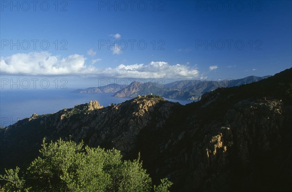 FRANCE, Corsica, "The Calanches in the city of Piana catch the first morning light, with the Scandola peninsula in the distance."