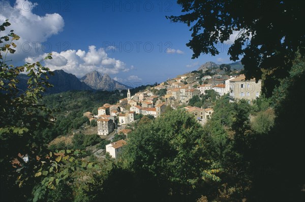 FRANCE, Corsica, "Morning in the hillside village of Evisa, with cumulus clouds crowning Capo D’Orto in the distance."