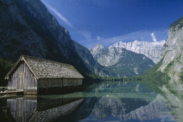 GERMANY, Berchtesgaden, Konigssee, A boathouse amidst tranquil water on the far side of the Obersee.