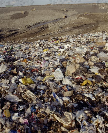 ENVIRONMENT, Rubbish, View across waste on a Infill site towards trucks used to move the rubbish