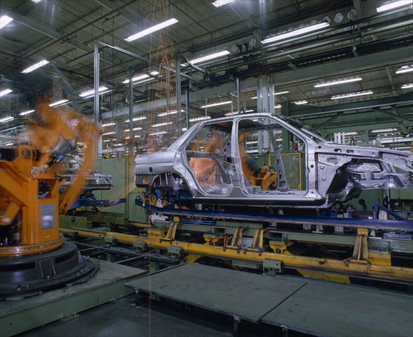 INDUSTRY, Cars, Ford Orion Car Production. Interior of factory with the shell of a silver car on production line.