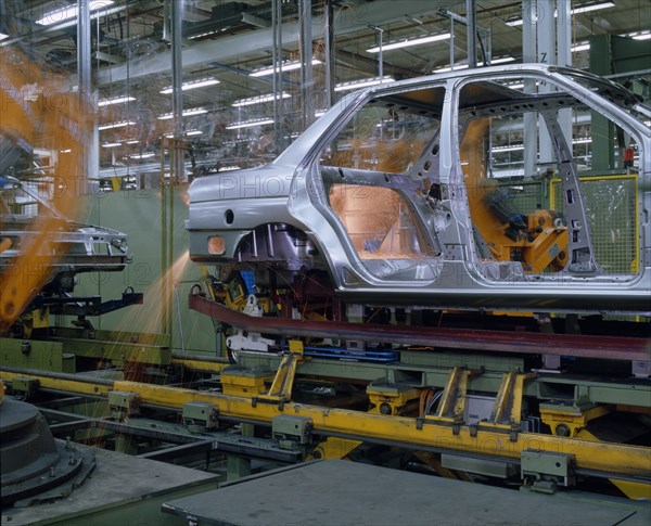 INDUSTRY, Cars, Ford Orion Car Production. Interior of factory with the shell of a silver car on production line.