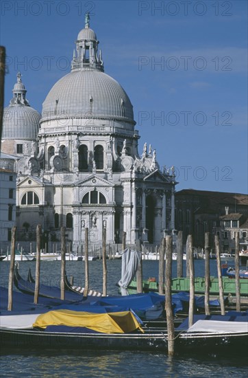 ITALY, Venice, Grand Canal. Church of Santa Maria Della Salute seen from across water and empty Gondola boats
