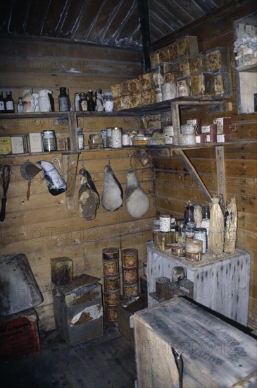 ANTARCTICA, Ross Sea, Ross Island, Cape Royds. Interior of Shackletons Hut built in 1908 with shelves of rusty tinned food containers