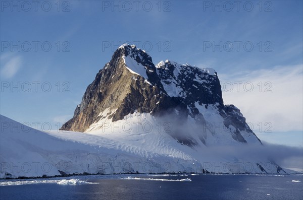 ANTARCTICA, Peninsula Region, View across water towards snow covered mountain