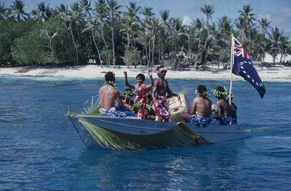 PACIFIC ISLANDS, Polynesia, Cook Islands, Manihiki Island. People traveling on boat welcoming visitors