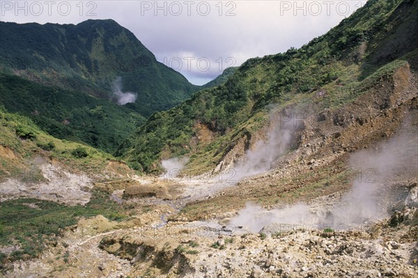 DOMINICA, Trois Pitons Nat. Park, Valley of Desolation, Landscape with steam rising from geysers on rocky valley floor.