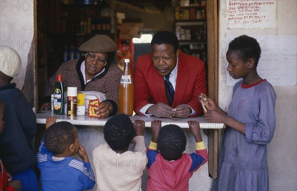 SOUTH AFRICA, Gauteng, East Rand, "Children at spaza shop.  Meaning camouflage, spaza was the name given to house shops, the only way for black South Africans to set up business in apartheid era"