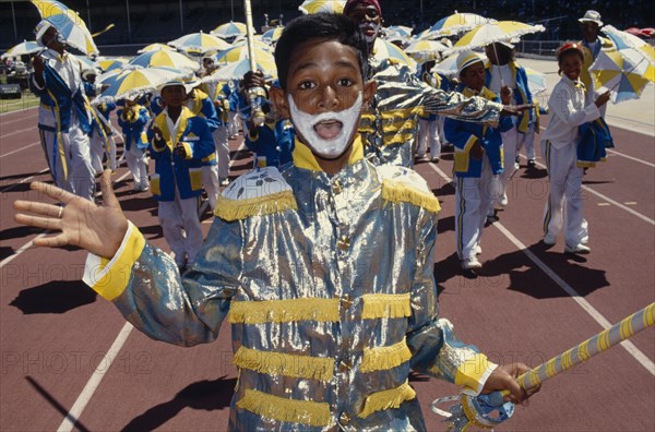 SOUTH AFRICA, Western Cape, Cape Town, Young boy in costume and face paint taking part in Cape Coon New Year carnival parade at Green Point Stadium.
