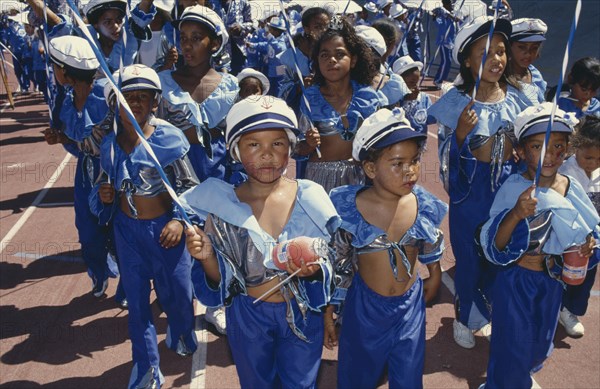 SOUTH AFRICA, Western Cape, Cape Town, Children in costumes and face paint taking part in Cape Coon New Year carnival parade at Green Point Stadium.