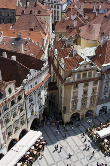 CZECH REPUBLIC, Bohemia, Prague, Restaurant and cafe tables with strolling pedestrians in the Old Town Square