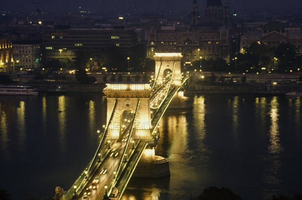 HUNGARY, Budapest, Bridge of Chains over the River Danube illuminated at night with lights from crossing traffic.