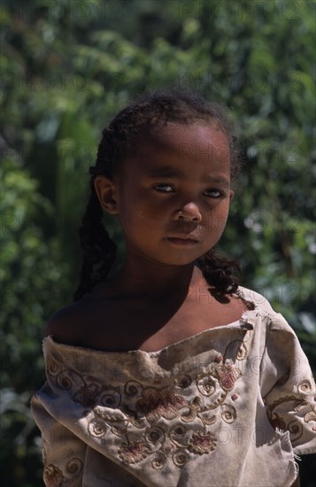 MADAGASCAR, People, Children, Road to Ambalavao. Portrait of a young girl wearing pig tails in her hair