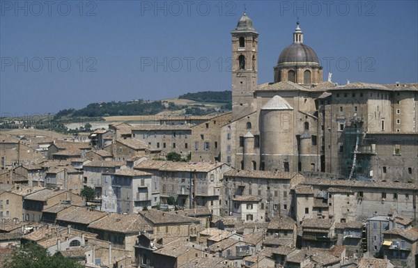 ITALY, Marche, Urbino, Palazzo Ducale rising above city rooftops.  Built for Duke Federico da  Montefeltro the ruler of Urbino between 1444 and 1482.