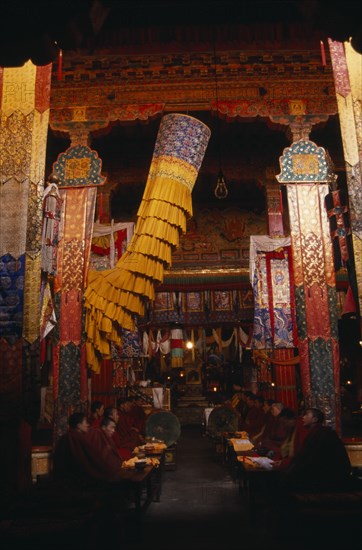 CHINA, Tibet, Monks chanting in the main chapel of Gonggar Chode Monastery near Lhasa Airport.